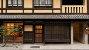A traditional Japanese building with a wooden facade, large sliding doors, and a tiled roof. - KIORI Collection Gokomachi (Kyoto)