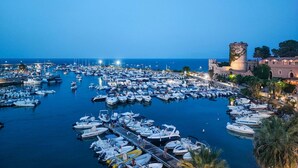 A marina with numerous boats docked, a historic tower, and a coastal view. - 3 bedroom stunning home in Trabia (Trabia)