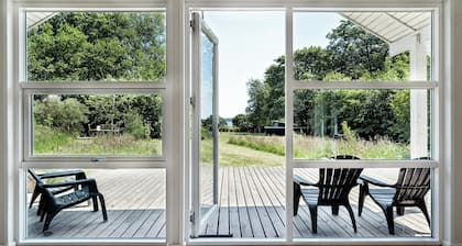 Forest house with stream by Hjarbæk Fjord
