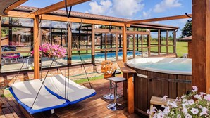 A wooden deck with a hot tub, a swing chair, and a pool view. - Awesome home in Darlowo with sauna (Darlowo)