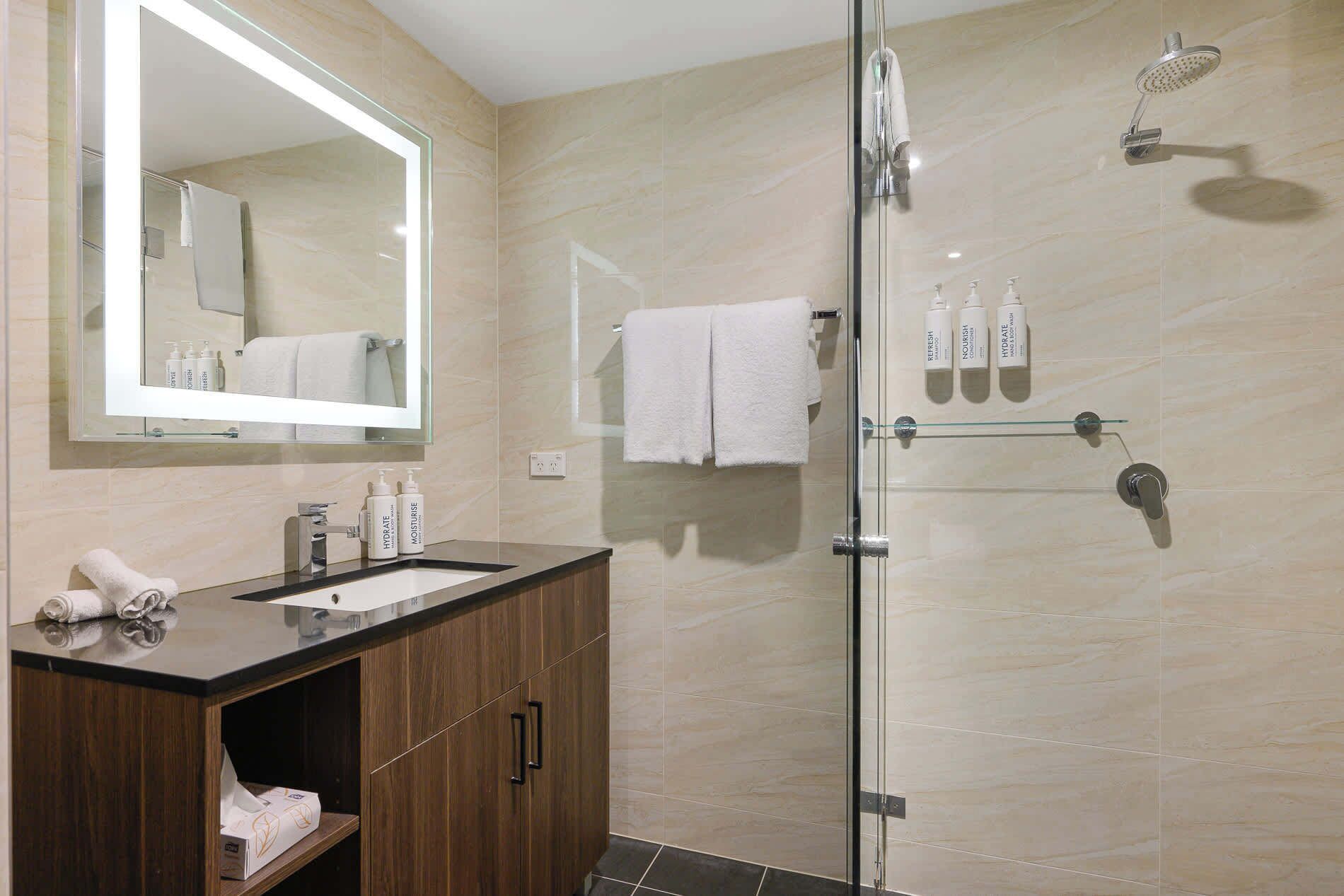 Shower, hair dryer, towels, shampoo