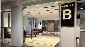 A hotel entrance with a reception desk, seating area, and elevators. - Serene 1-bedroom Apartment in Boracay With Pool Access (Boracay Island)