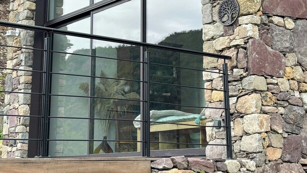 A stone building with large windows and a wooden deck. - 17th century renovated barn in Valdeblore (Valdeblore)