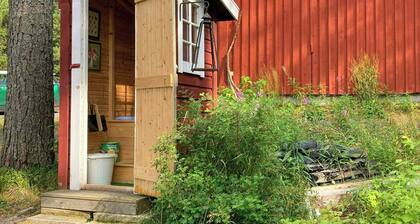 18th-century timber house by sea bay near Umeå