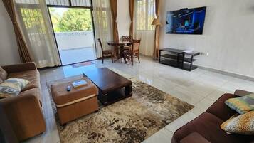 Deluxe Apartment | Living area | 24-inch Smart TV with digital channels