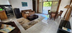 Deluxe Apartment | Living area | 24-inch Smart TV with digital channels - Salaam Green Homestays Diani  (Diani Beach)