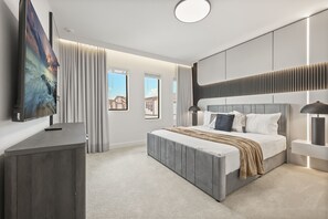 A modern bedroom with a large bed, a flat-screen TV, and a view of the outside. - 15 BD/ 16.5 BA/ Sonoma Resort (4141 SB) (Kissimmee)