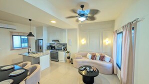 A modern kitchen with a built-in oven, microwave, and granite countertop. - Cana Life | Tropical Haven 2 (Punta Cana)