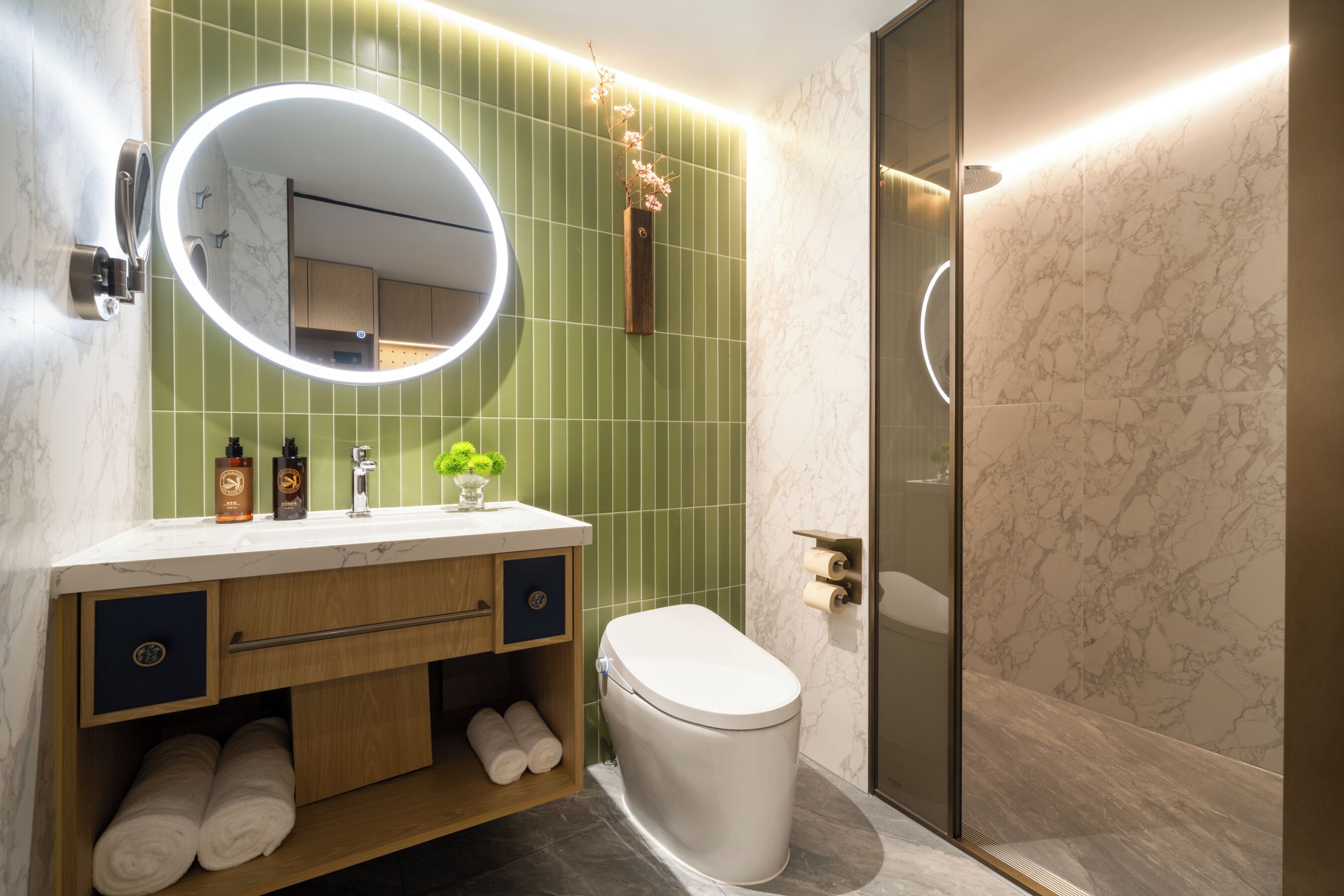 A modern bathroom with a toilet, sink, and shower.