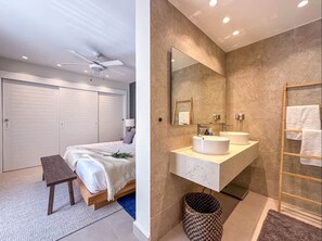 A bedroom with a bed, bedside table, and a ceiling fan. - Cana Life Luxury | Sky Palace Penthouse (Punta Cana)