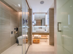 A modern bathroom with a glass shower enclosure, a toilet, a sink, and a mirror. - Lavande International Huawei Guangzhou  (Guangzhou)