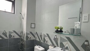 A bathroom with a toilet, sink, and shower. - Nhà Sài Gòn (Ho Chi Minh City)