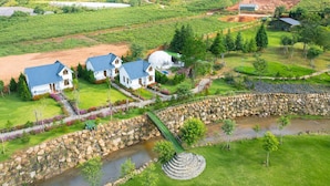 A residential area with houses, a stone bridge, and a river.