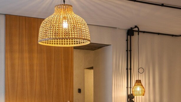 A bedroom with a bed, a chair, a hanging lamp, and a wooden wardrobe. - ALMA - Island House by GuestReady (Faial da Terra)