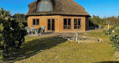 Octagonal thatched forest house near Herning