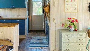 A wooden interior with a kitchen area, a hallway, and a white dresser with drawers. - Summer house near beach in Odder (Odder)