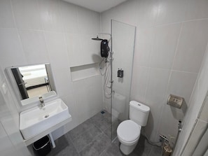 A bathroom with a white sink, a toilet, and a shower enclosure. - One Point Hotel TT3 Tabuan Tranquility (Kuching)