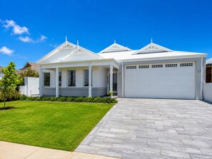 A modern two-story house with a covered porch, a garage, and a well-maintained lawn. - Winter Mornings on the Canal - A Waterside Paradise (Geographe)