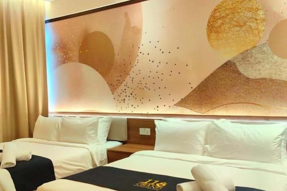 A hotel room with two beds, a large abstract wall art piece, and a modern design.