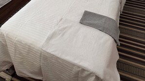 Two single beds with wooden headboards, white linens, and teal pillows. - Paru home 2bhk Apartment Everest (Kathmandu)