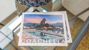 A postcard with a pool and palm trees, titled 'Greetings from COACHELAND.' - Entire Building | One 4BR + Two 2BRs | 22 Guests | Resort Pool | Summerwell (La Quinta)