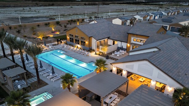 A resort with a swimming pool, outdoor seating, and a large building with multiple rooms. - Entire Building | One 4BR + Two 2BRs | 22 Guests | Resort Pool | Summerwell (La Quinta)