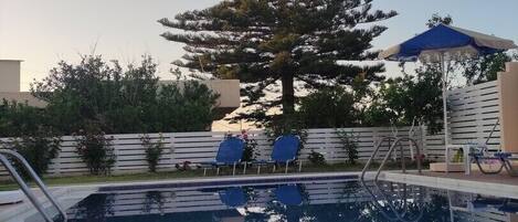 Seasonal outdoor pool, open 8:00 AM to midnight, pool umbrellas