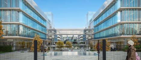 A modern building with glass facades and a central courtyard.