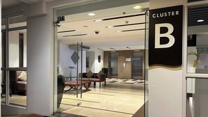 A hotel entrance with a reception desk, seating area, and elevators. - Serene 1-Bedroom Apartment in Boracay with Pool Access (Boracay Island)