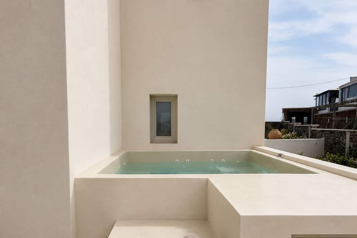 A spa area with a hot tub, steps, and a towel.