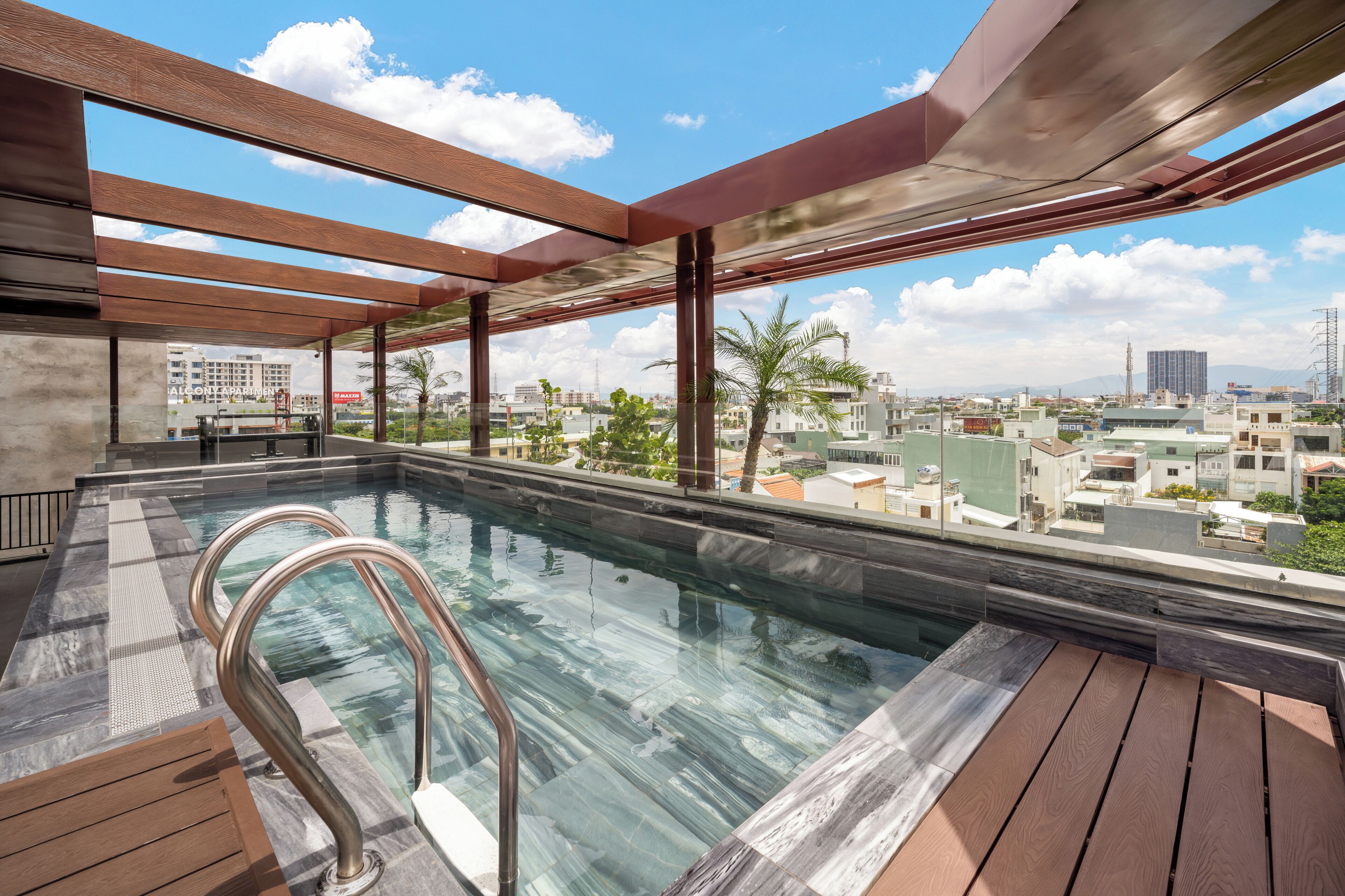 A rooftop swimming pool with a clear view of the cityscape.