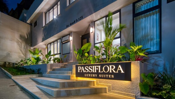 A modern building with a sign for 'Passiflora Luxury Suites' at the entrance. - Passiflora luxury suite (Cali)
