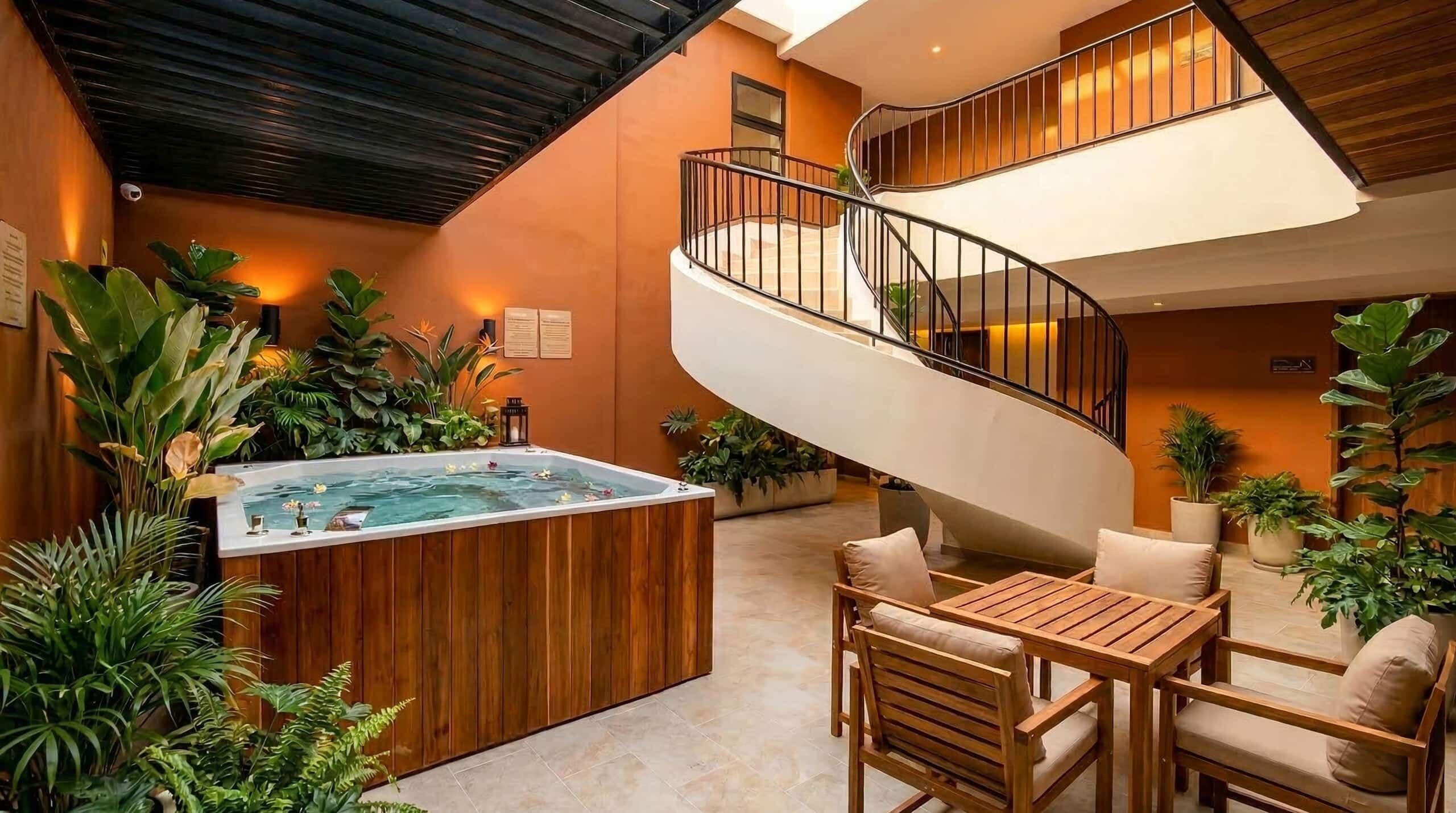 A spa area with a hot tub, wooden seating, and a spiral staircase.