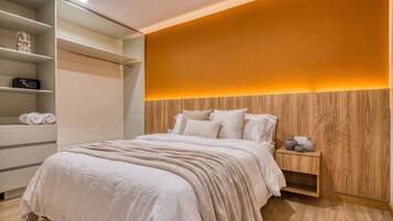 A bedroom with a bed, bedside table, and a wardrobe.