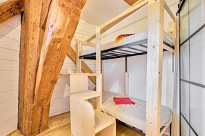 A bunk bed room with wooden beams, a desk, and a chair. - fewo1846 - Westwind - Vacation in a historic windmill with max. 4 persons (Flensburg)