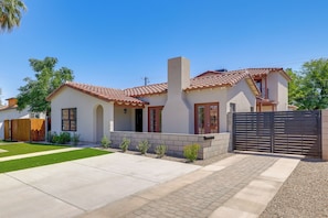 A modern two-story house with a tiled roof, a brick chimney, and a gated driveway. - Easy Dtwn Access! Prime PHX Stay For Couples (Phoenix)