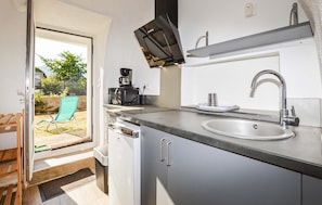A compact kitchen with a built-in microwave, a sink, and a coffee maker. - 1 bedroom amazing apartment in Moriani-Plage (Moriani-Plage)