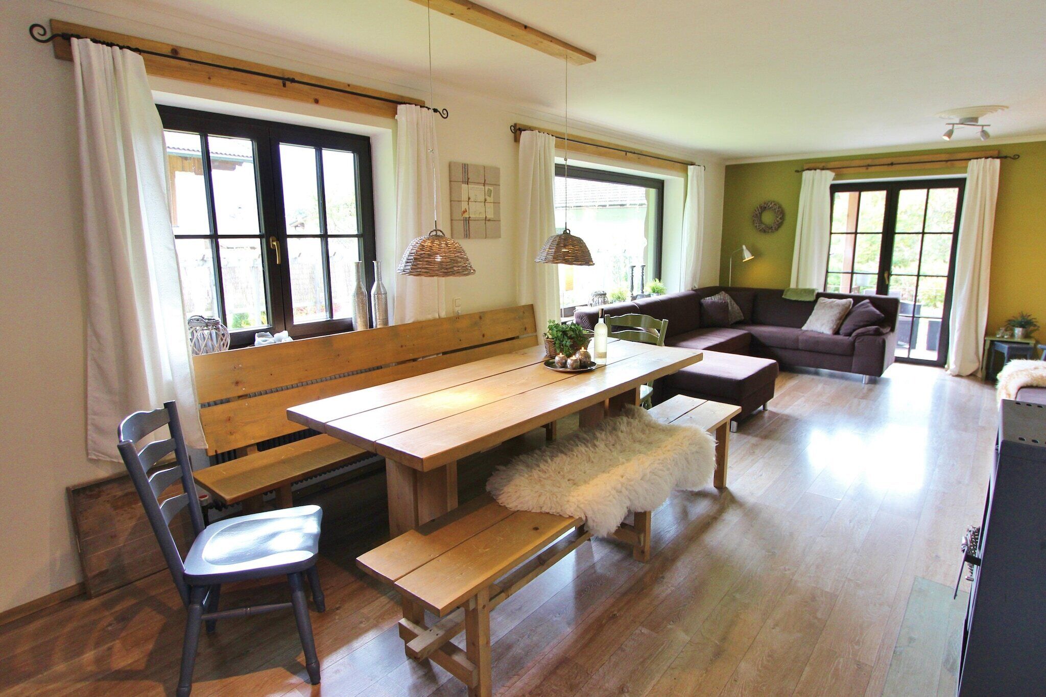 A dining area with a wooden bench, a table, and a chair.