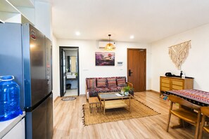 Deluxe Apartment, 2 Bedrooms, Balcony, City View | Living area | Flat-screen TV