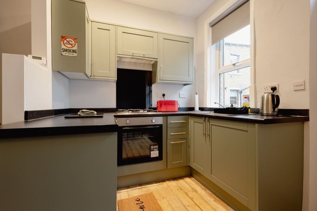A kitchen with a stove, oven, and cabinets.