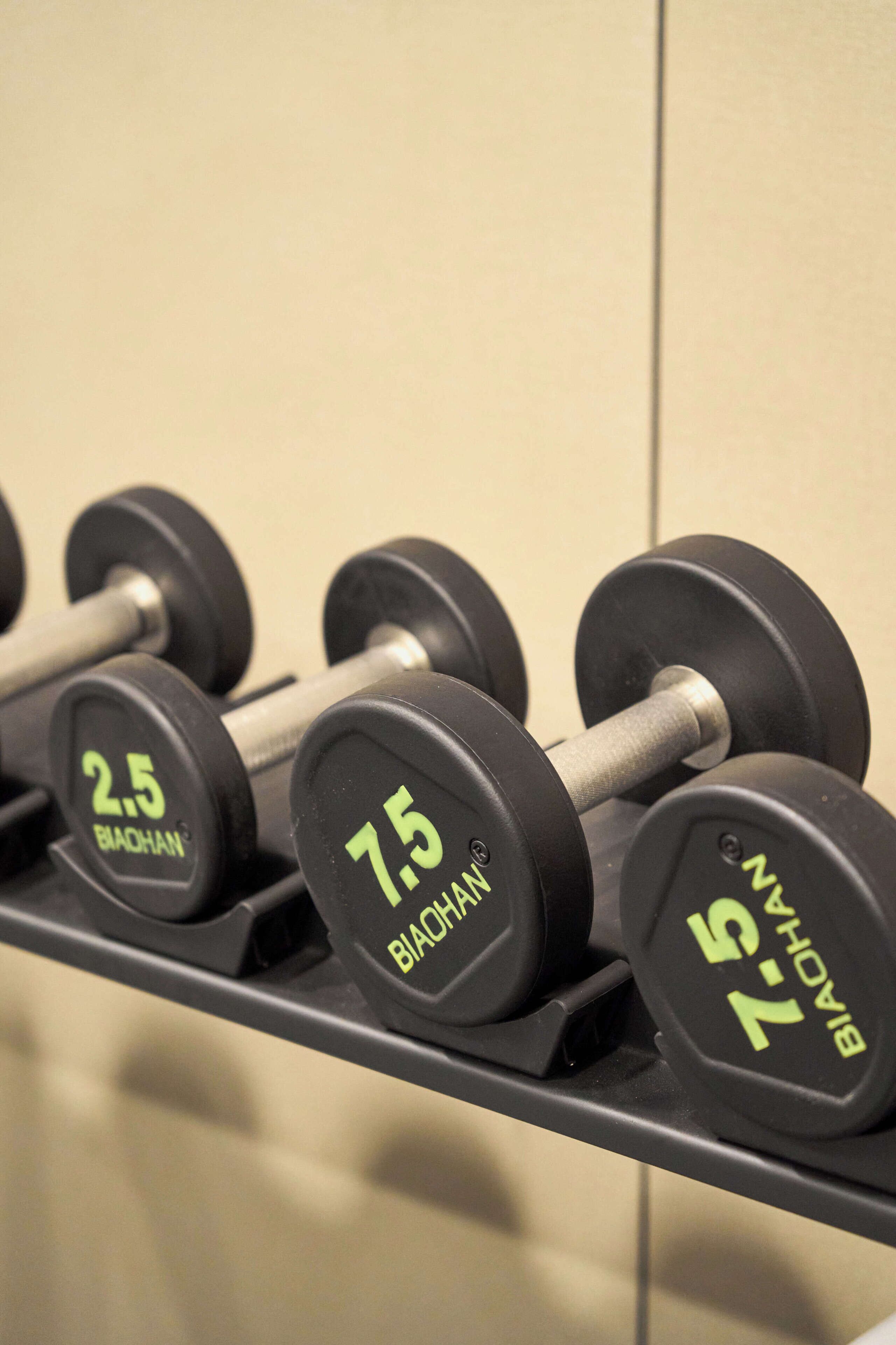A rack of dumbbells with weight markings.