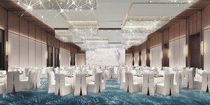A spacious banquet hall with rows of tables and chairs, a large screen at the front, and a ceiling with a geometric light fixture. - Hyatt Regency Zhuhai Airport (Zhuhai)
