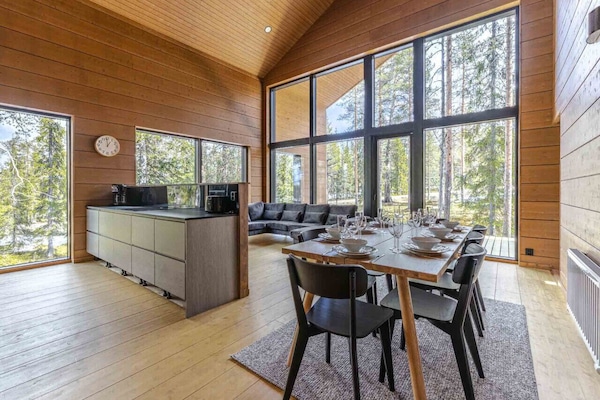 The expansive dining table comfortably seats your entire group for gourmet meals prepared in our fully equipped, modern kitchen. Floor-to-ceiling windows ensure you never miss a moment of the surrounding Lapland scenery while you dine.