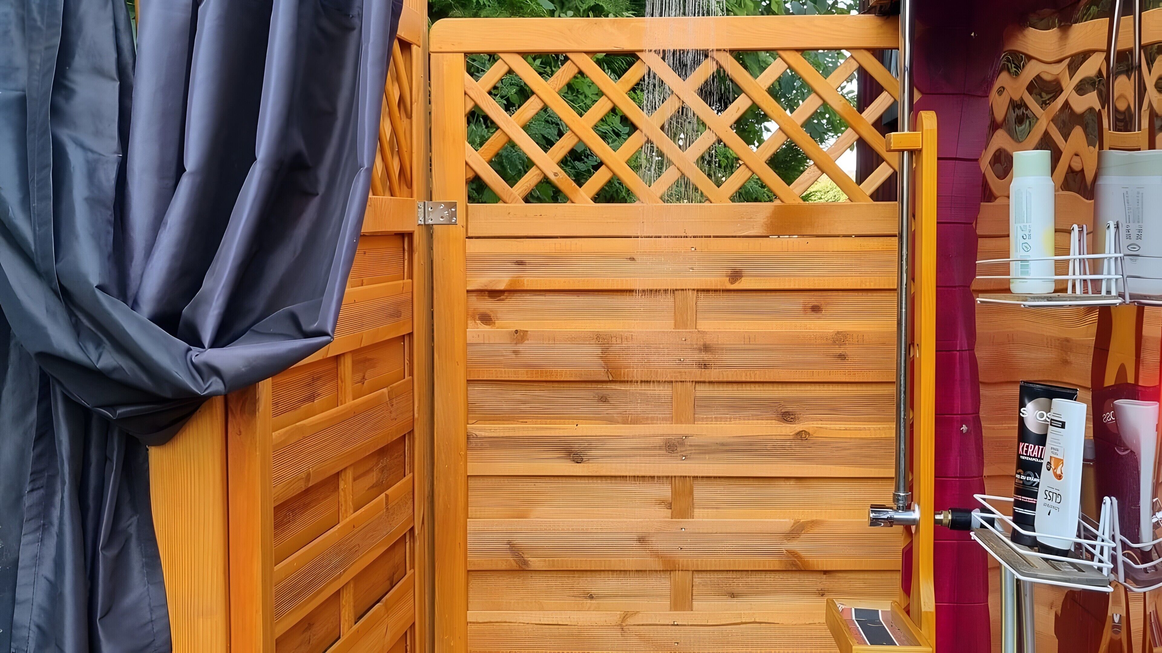 A wooden gate with a lattice design, a metal handle, and a small step leading to a door.