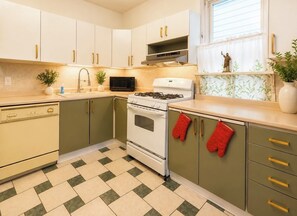 A kitchen with a stove, oven, microwave, and cabinets. - 1st Floor Spacious Apt with Deck (Kearny)