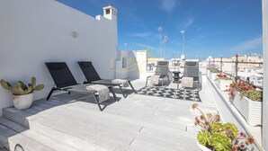 A rooftop terrace with two lounge chairs, a small table, and potted plants. - TD Casa Altomare w/ Terrace Over Historic Center (Monopoli)