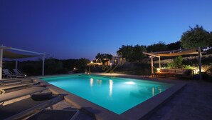A swimming pool with lounge chairs and a covered seating area. - TD Trulli Altura With Pool & Stunning Sunsets (Martina Franca)