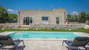 A stone house with a swimming pool, two lounge chairs, and a stone wall. - TD Villa Coco Countryside Villa Near Ostuni (Ostuni)