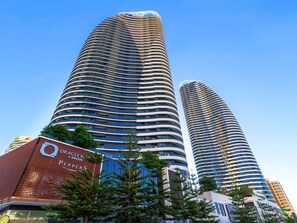 Two high-rise buildings with a curved facade, one with a visible sign for 'Oracle by Nicon Peppers.' - Oracle Skyview | Luxury 26th Floor Ocean Escape (Gold Coast)