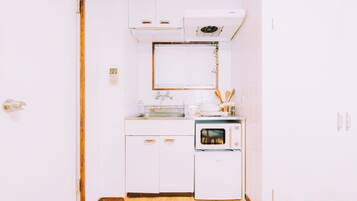 Apartment | Private kitchen | Mini-fridge, microwave, stovetop, cookware/dishes/utensils